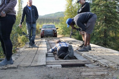Colin sets up a shot on a rickety wooden bridge